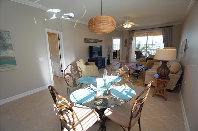 tiled dining area featuring ceiling fan and crown molding