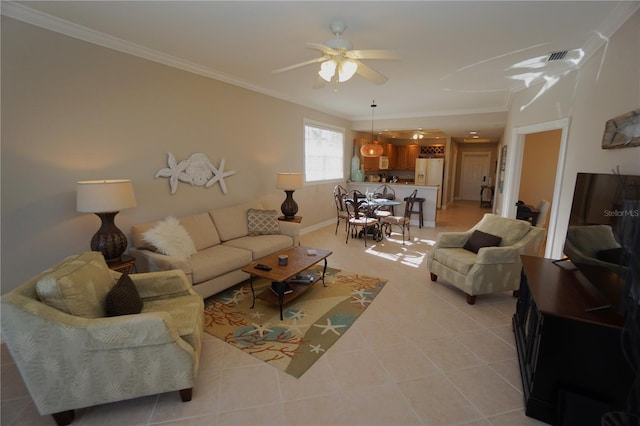 living room with light tile patterned floors, ceiling fan, and ornamental molding