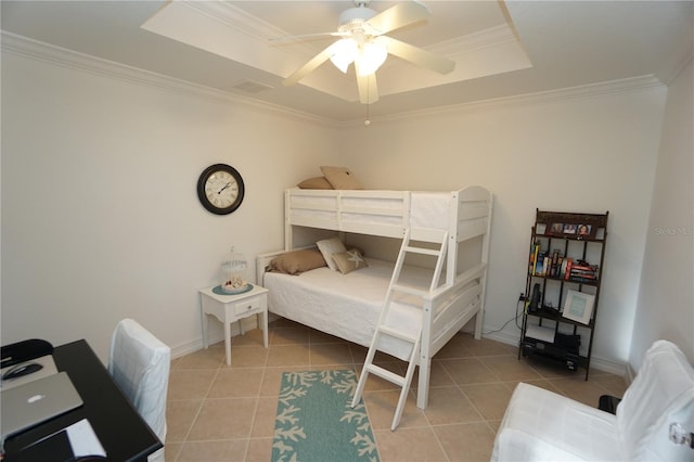 tiled bedroom featuring ceiling fan, a raised ceiling, and crown molding