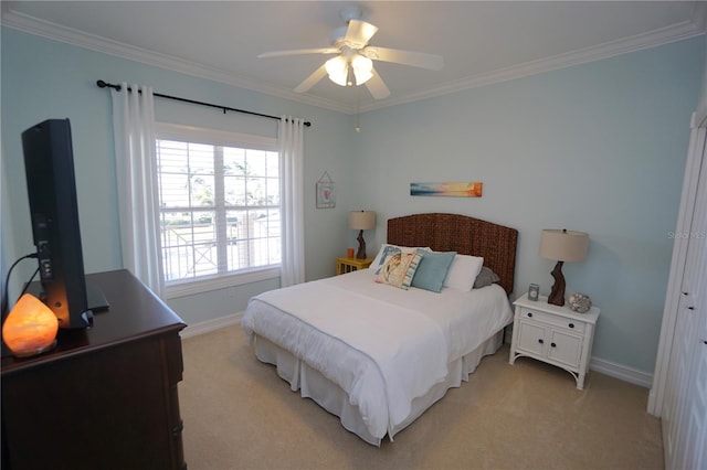 bedroom featuring ceiling fan, ornamental molding, and light carpet