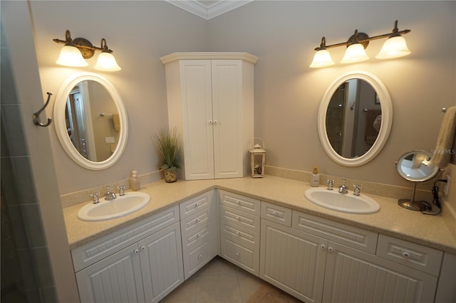 bathroom featuring tile patterned flooring, vanity, and crown molding