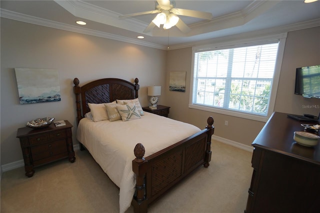 carpeted bedroom featuring ceiling fan, a raised ceiling, and ornamental molding