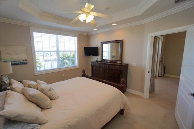 bedroom with a tray ceiling, ceiling fan, and crown molding