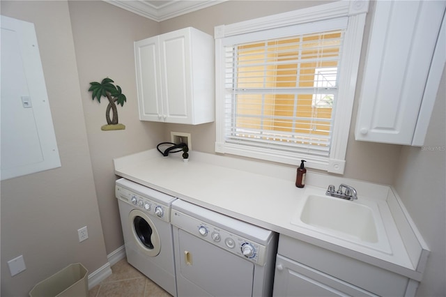 laundry area featuring cabinets, crown molding, sink, washer and dryer, and electric panel