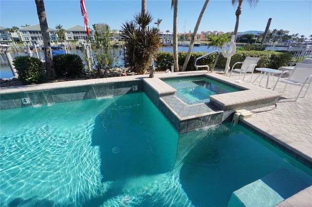 view of swimming pool with a water view and an in ground hot tub