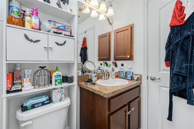 bathroom featuring vanity and toilet