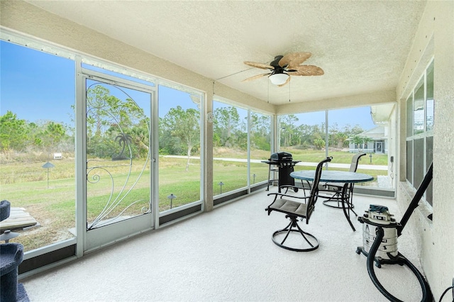 sunroom / solarium with ceiling fan