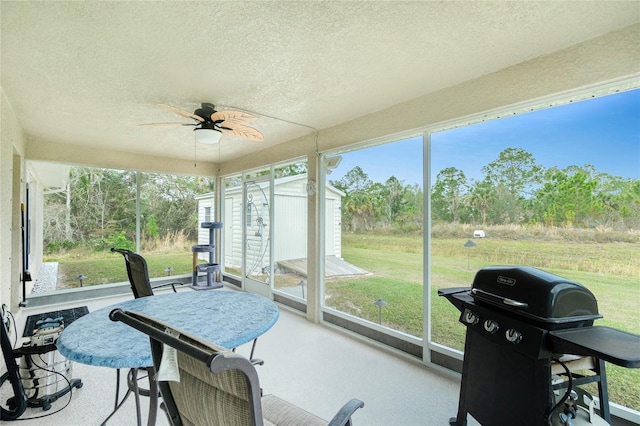 sunroom featuring ceiling fan