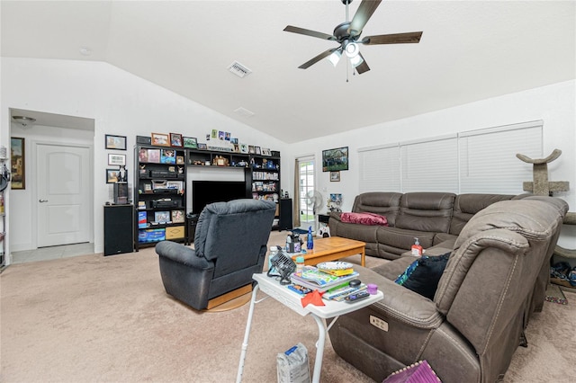 living room with ceiling fan, vaulted ceiling, and carpet