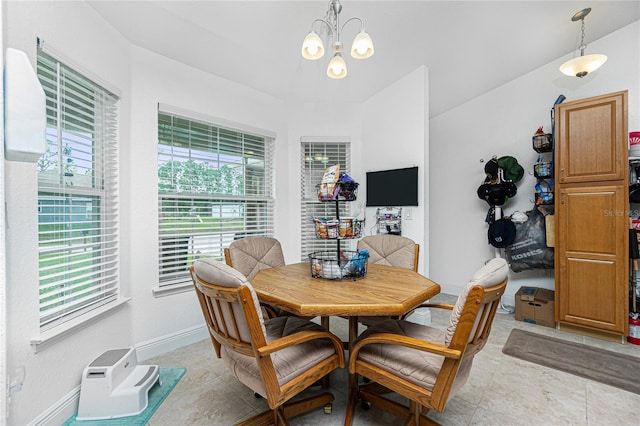 dining area with light tile patterned floors and an inviting chandelier