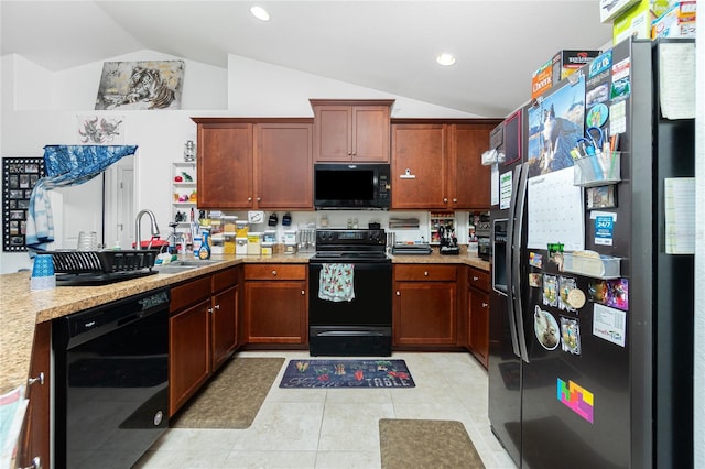 kitchen with lofted ceiling, sink, light stone counters, light tile patterned flooring, and black appliances