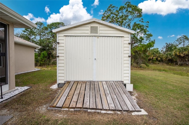 view of outbuilding with a yard