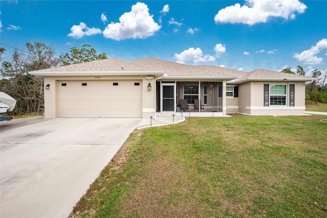 single story home featuring a front lawn and a garage