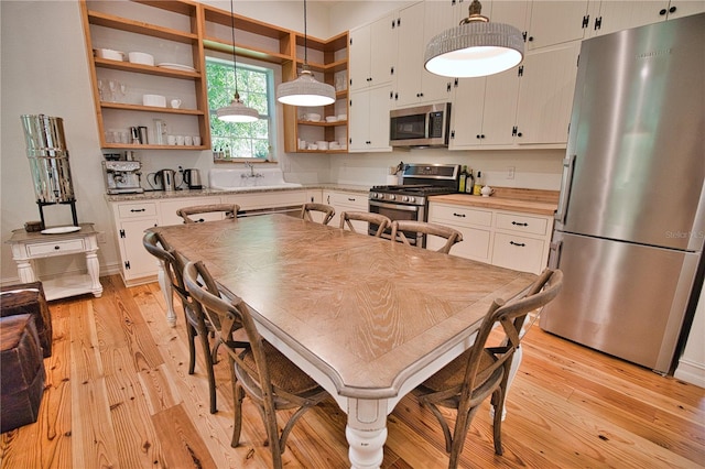 dining space featuring sink and light wood-type flooring