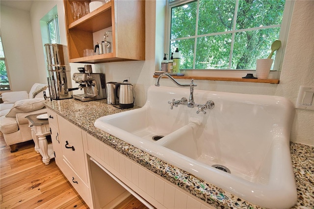 bathroom featuring wood-type flooring, sink, and a wealth of natural light