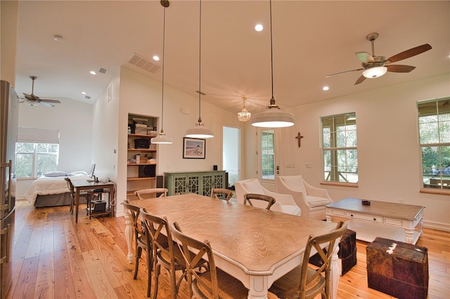 dining area with ceiling fan, light hardwood / wood-style floors, and lofted ceiling