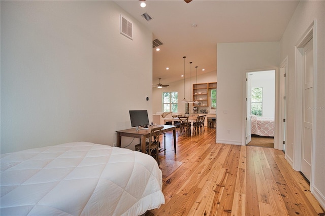 bedroom featuring light hardwood / wood-style floors and lofted ceiling