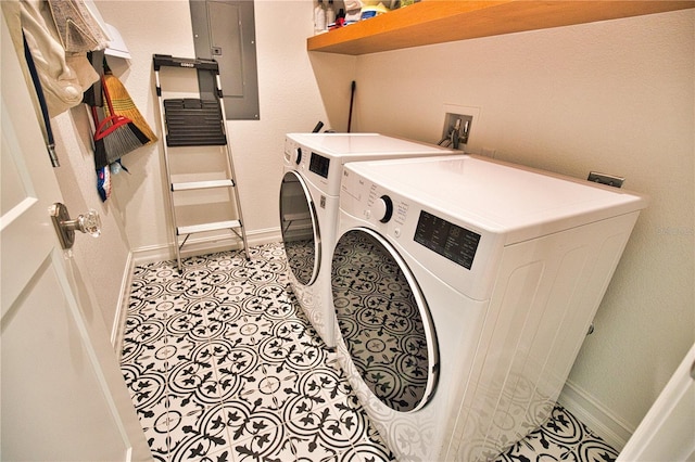 laundry area featuring independent washer and dryer, electric panel, and light tile patterned floors