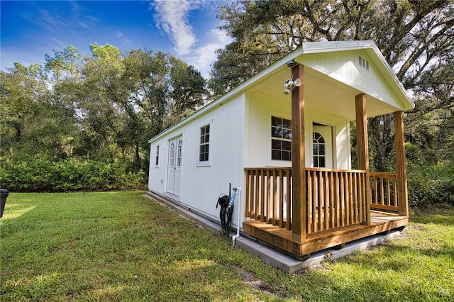 view of home's exterior featuring a porch and a lawn