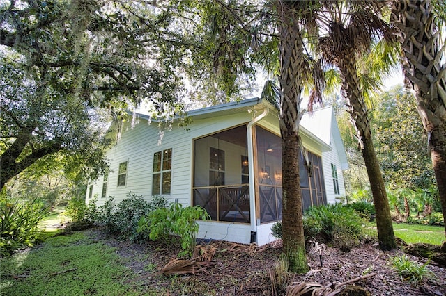 view of side of property with a sunroom