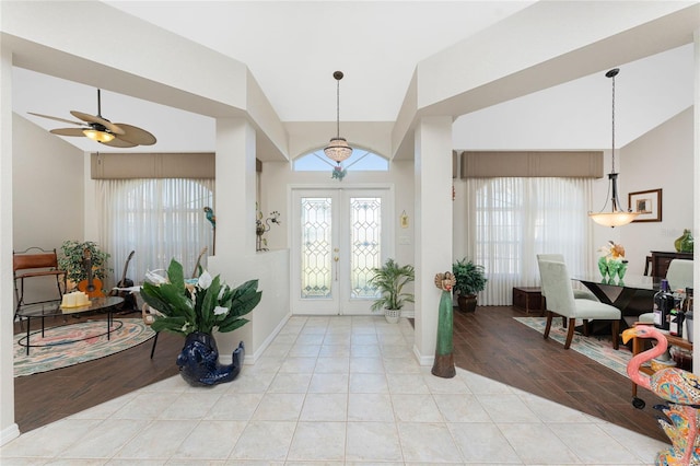 tiled foyer featuring ceiling fan and french doors