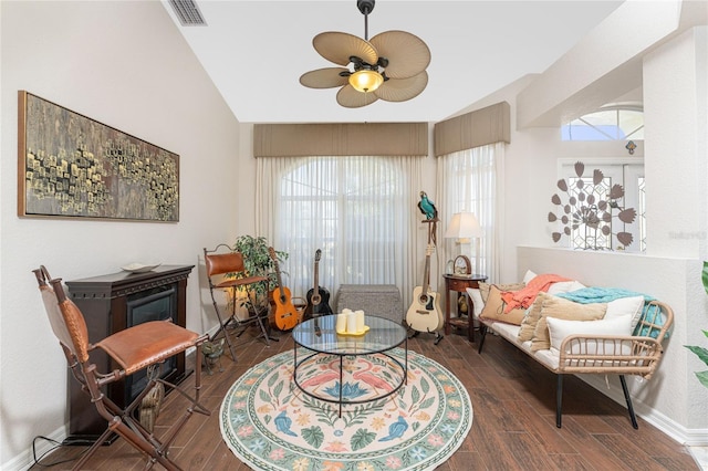 living area featuring dark hardwood / wood-style floors, vaulted ceiling, and ceiling fan