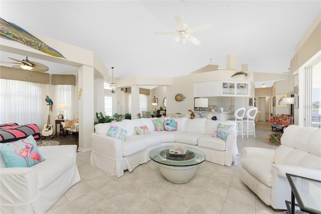 living room featuring vaulted ceiling, ceiling fan, and light tile patterned flooring