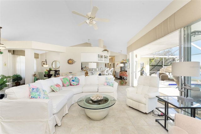 tiled living room with ceiling fan and vaulted ceiling