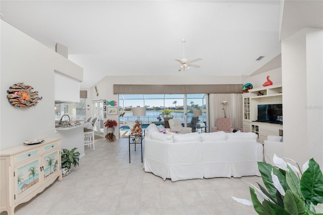 living room featuring ceiling fan and lofted ceiling