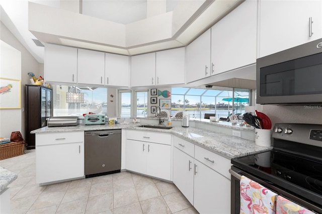 kitchen featuring white cabinets, light stone countertops, sink, and appliances with stainless steel finishes