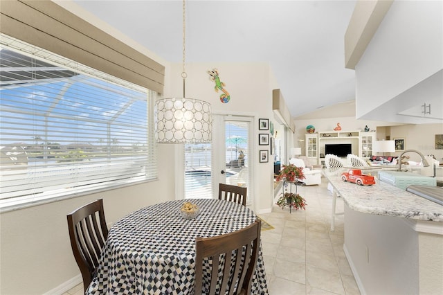 dining area featuring light tile patterned floors and vaulted ceiling