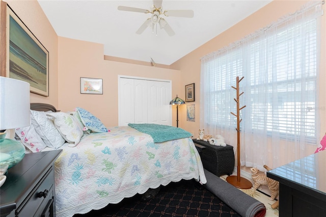 bedroom with ceiling fan and a closet