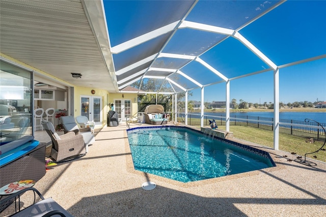 view of swimming pool featuring glass enclosure, french doors, a water view, and a patio