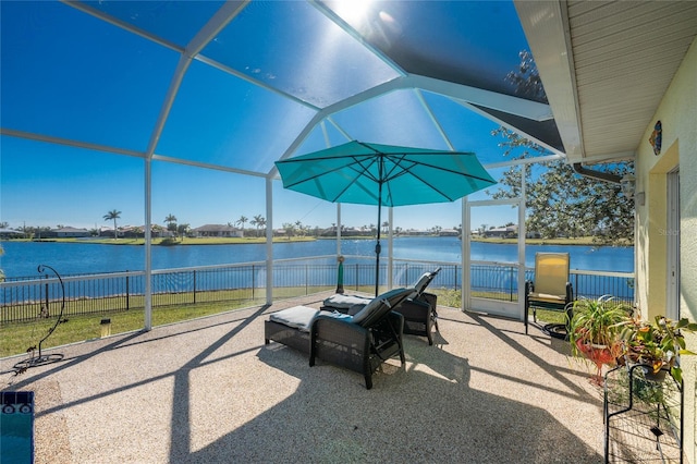 view of patio / terrace with a lanai and a water view