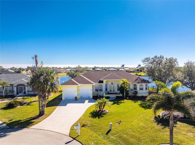 ranch-style home with a garage, french doors, and a front lawn