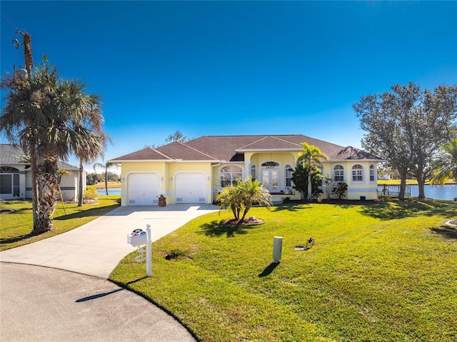 view of front of home with a front lawn and a garage