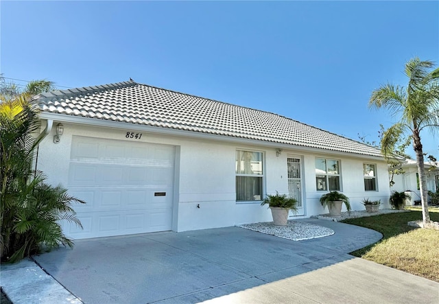 ranch-style home featuring a garage