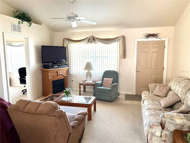 carpeted living room featuring ceiling fan and vaulted ceiling