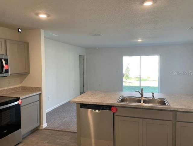 kitchen with gray cabinetry, sink, a textured ceiling, and appliances with stainless steel finishes