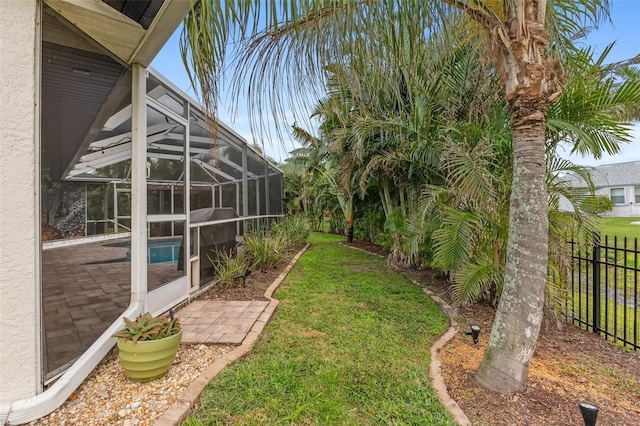 view of yard featuring glass enclosure