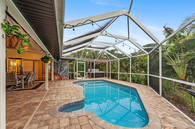 view of swimming pool featuring a lanai and a patio area