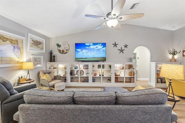 living room featuring ceiling fan, lofted ceiling, and light wood-type flooring