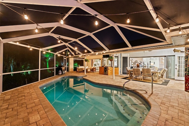 view of swimming pool featuring a patio and a lanai