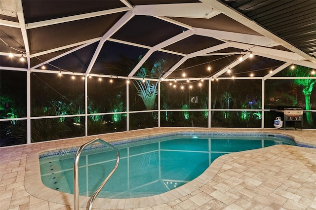 view of swimming pool featuring grilling area and glass enclosure