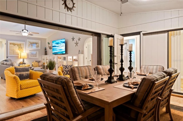 dining area featuring ceiling fan, vaulted ceiling, and light wood-type flooring