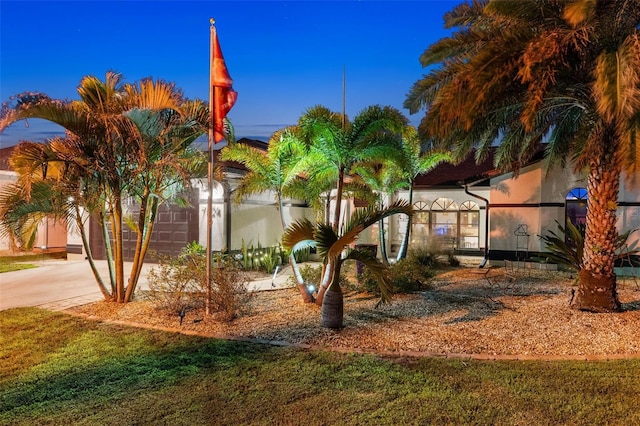 exterior space featuring a garage and a front yard