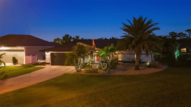 view of front facade with a garage and a lawn