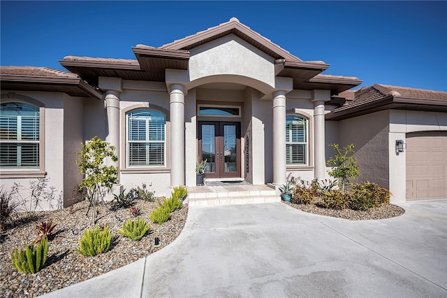 doorway to property with french doors and a garage