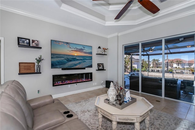 tiled living room featuring ornamental molding, a raised ceiling, and a wealth of natural light