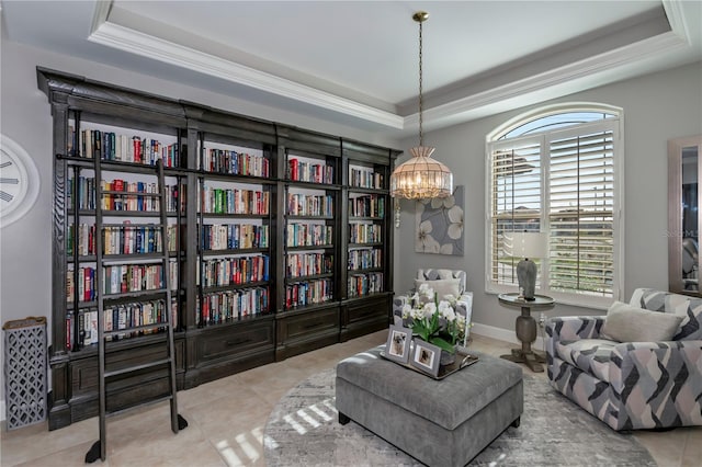 sitting room with light tile patterned floors, a tray ceiling, and a notable chandelier